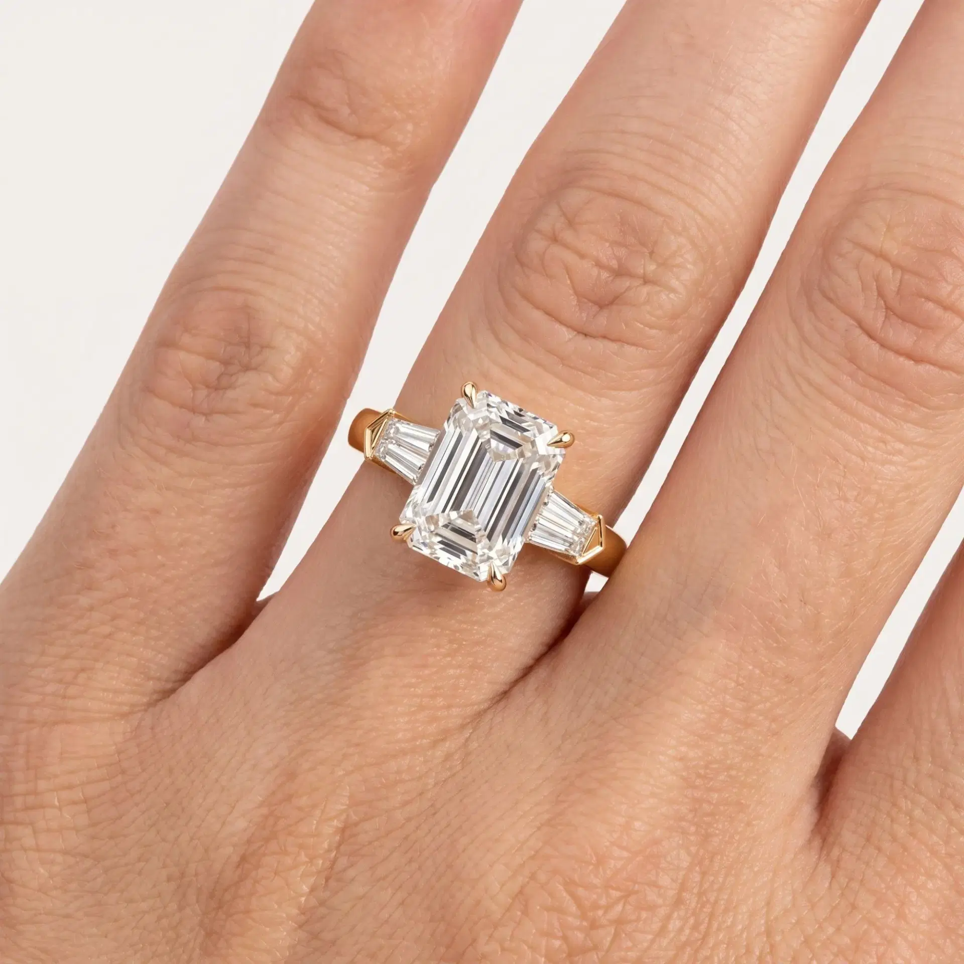 Tapered Baguette and Emerald Cut Diamond Ring on model