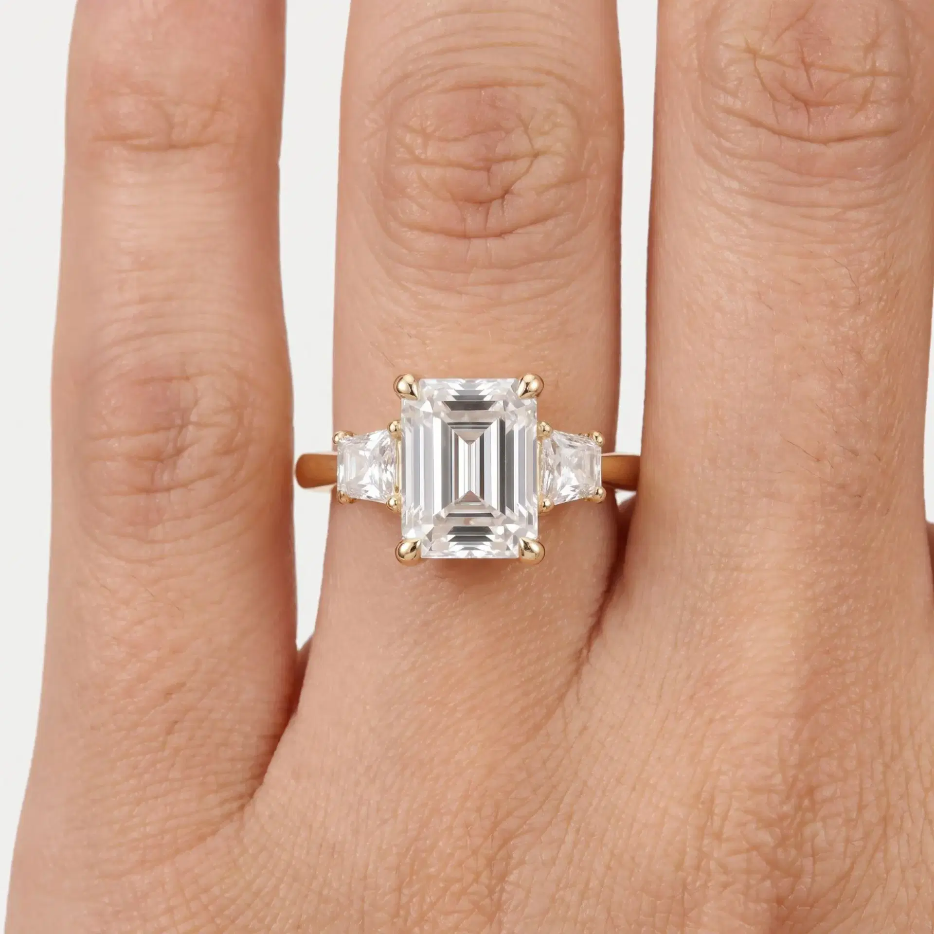 Emerald & Trapezoid Diamond Three Stone Ring on model