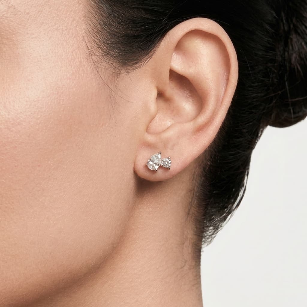 Two of Us — Pear & Round Diamond Two-Stone Stud Earrings on model