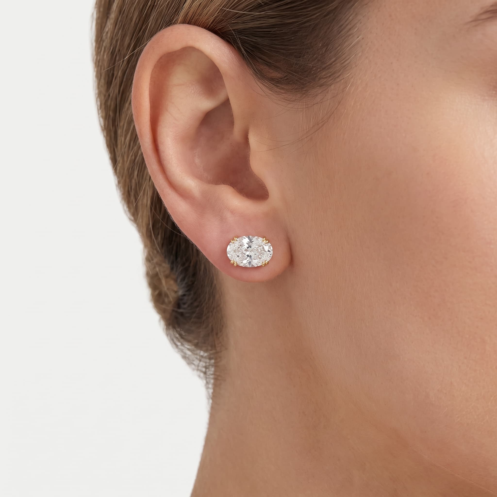 Radiant Glow — Oval Cut Diamond Threaded Stud Earrings on model