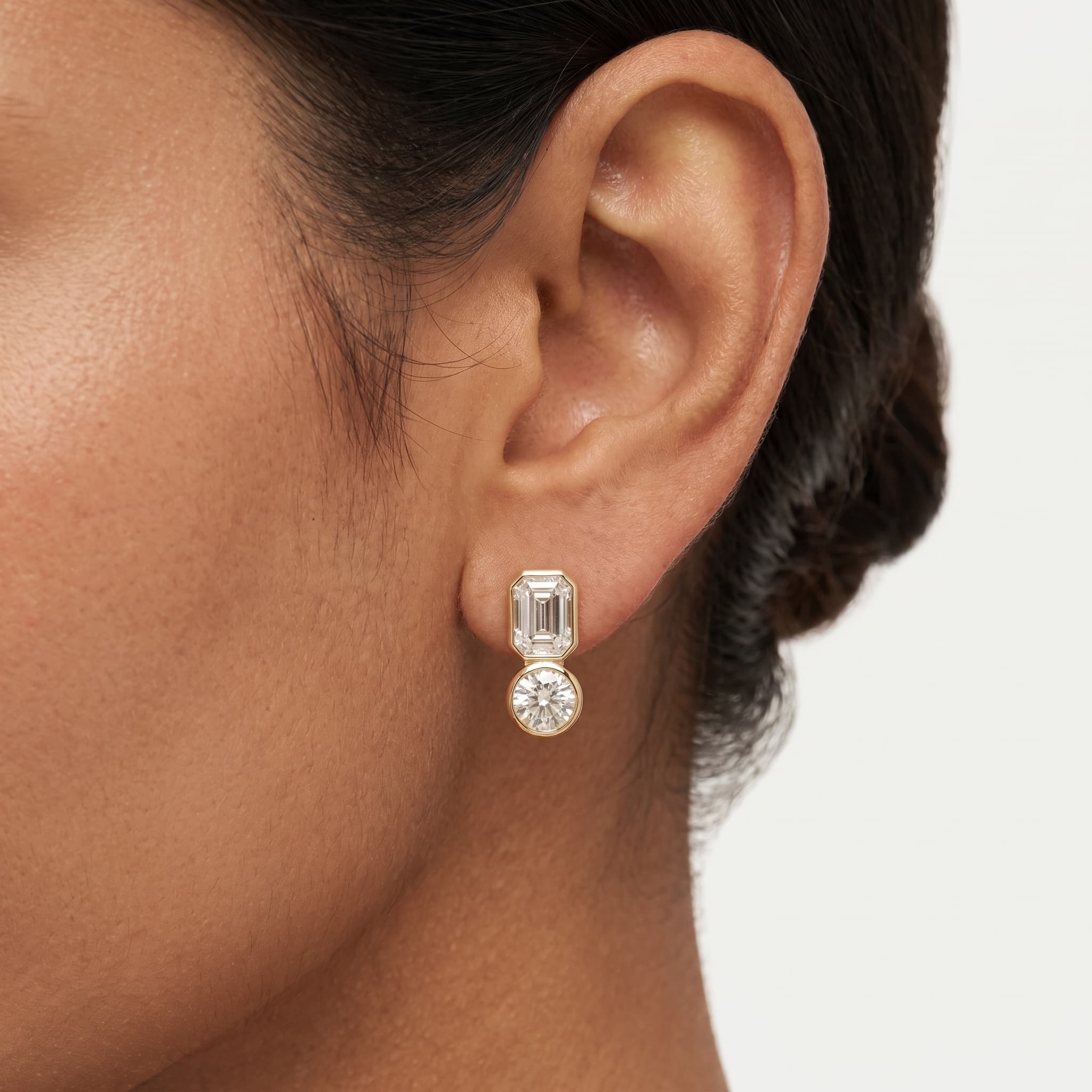 Two-Tier Glow — Emerald & Round Diamond Bezel Drop Stud Earrings on model
