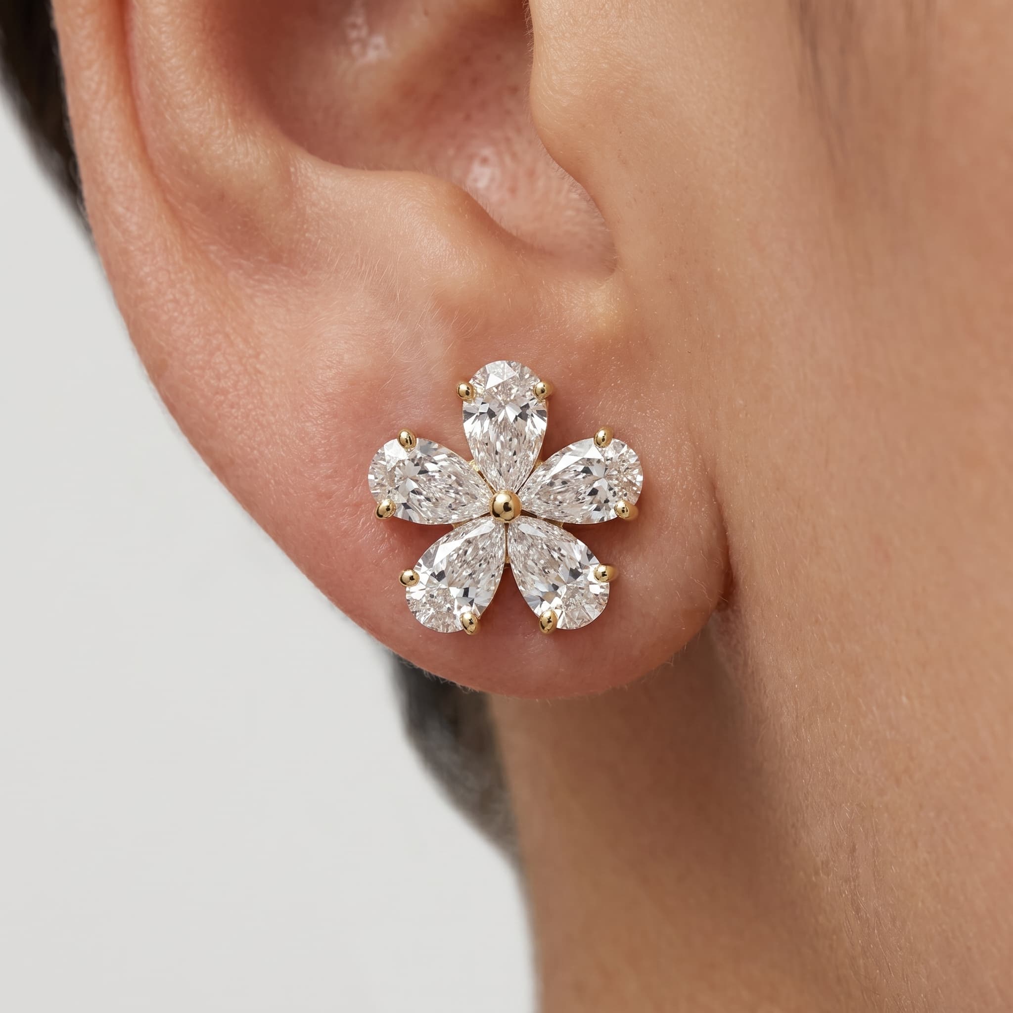 Five Petals — Pear Cut Diamond Flower Stud Earrings on model